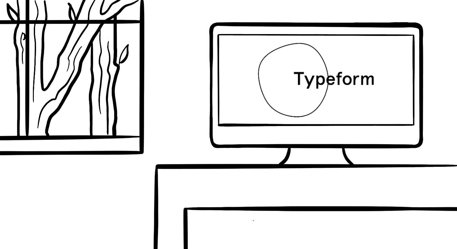 Typeform logo on a computer screen on a desk near a window with a tree in the background