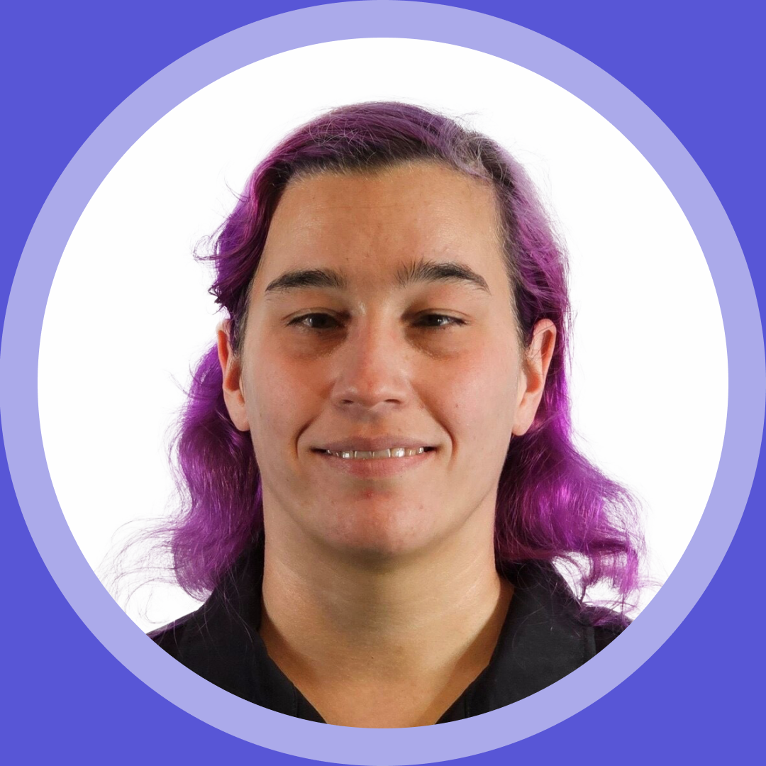 Thumbnail image. Portrait of Caitlin W. a woman with long, wavy purple hair, wearing a black top, set inside a purple circular frame.