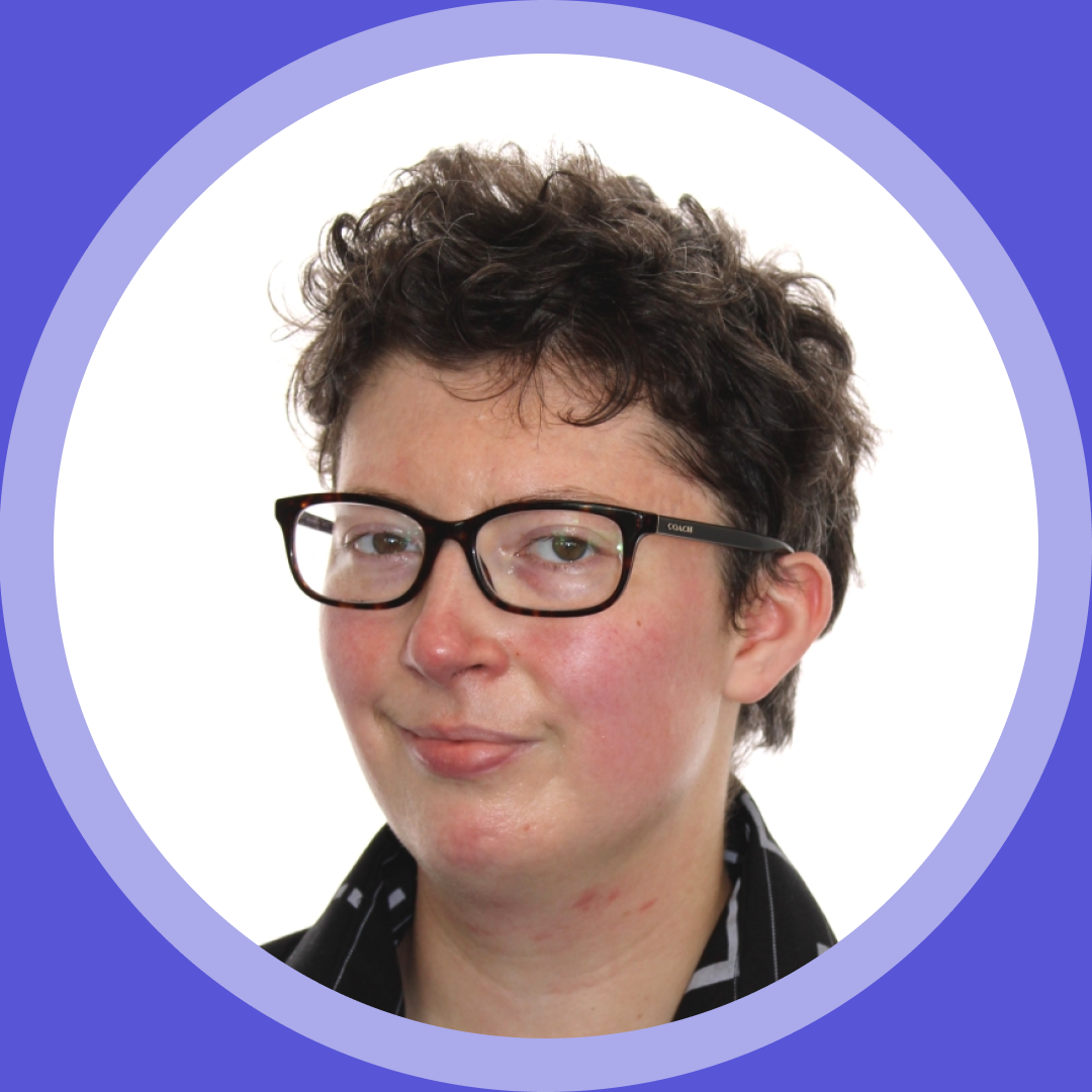 Thumbnail image. Portrait of Rowan P, a person with short, curly dark hair wearing black rectangular glasses and a black collared shirt, set inside a circular frame.