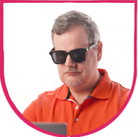 Fable Community member headshot Man wearing dark sunglasses and an orange shirt, standing against a light background and looking at a screen