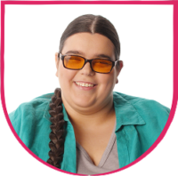 Fable Community member headshot 3 Woman with braided hair wearing tinted glasses and a teal shirt, smiling at the camera